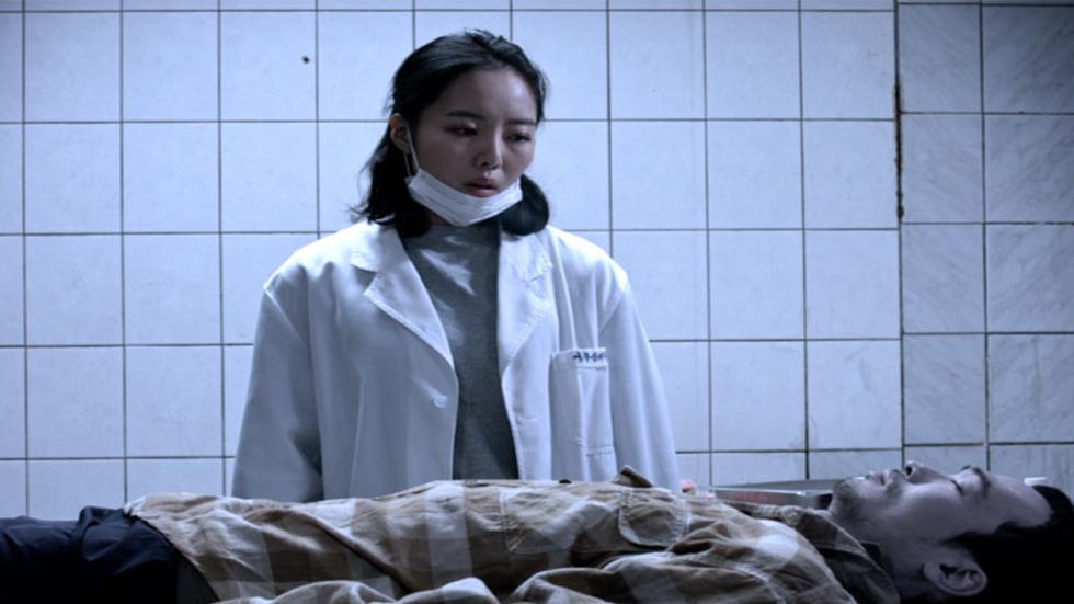 The Ghost film still woman mortician looks over dead body