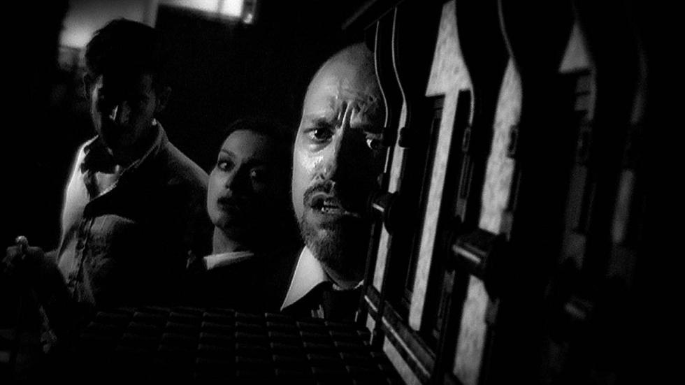 The Laplace's Demon film still 2 men and a woman look at something in fear.