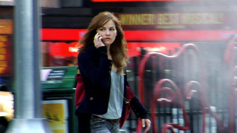 The Collective woman walks in the city talking on her phone
