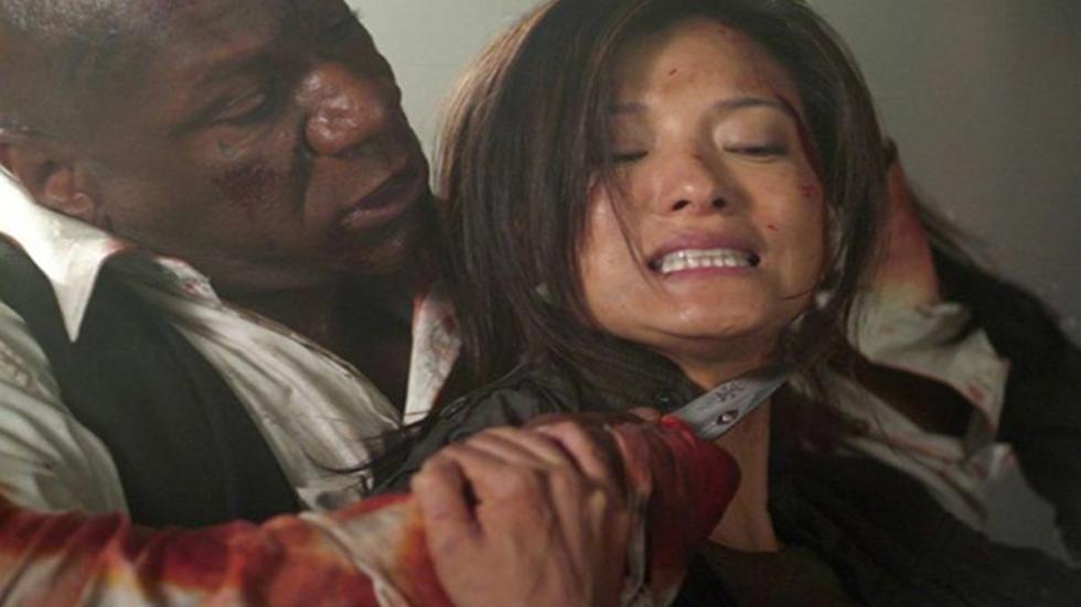 The Tournament a man holds a knife to a woman's neck
