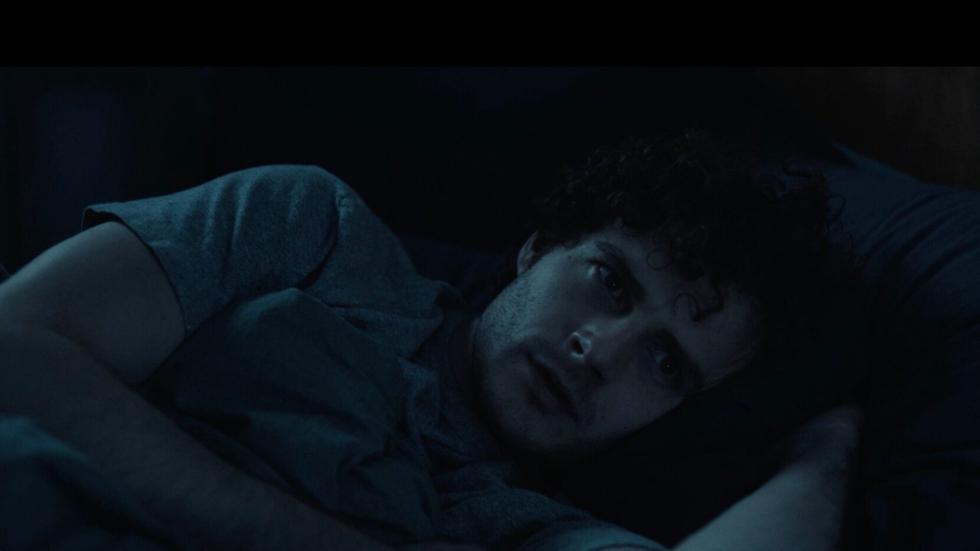 A man lays in bed
