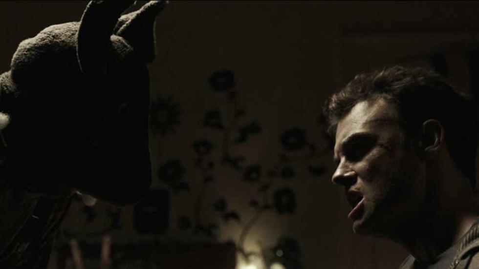 Torment man looks at creature