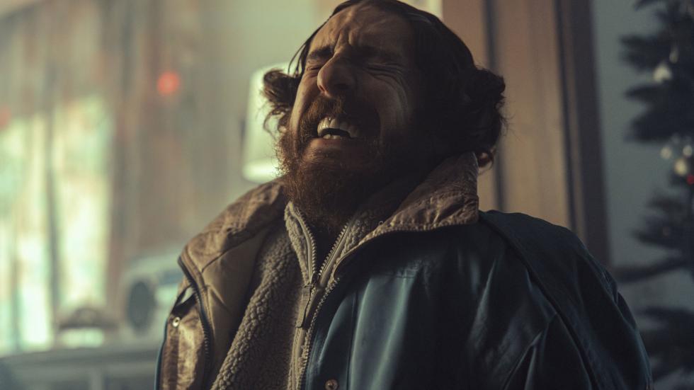 One thug grimaces in pain
