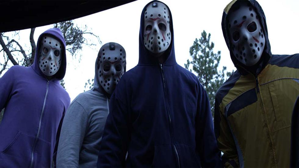 The Unraveling masked men looking on 