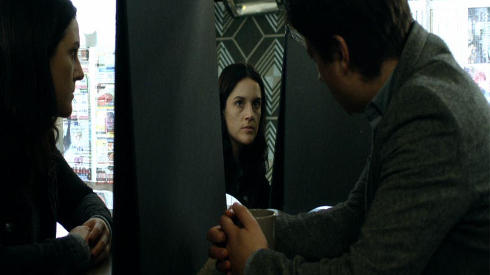 Unseen film still woman speaks with man using a mirror