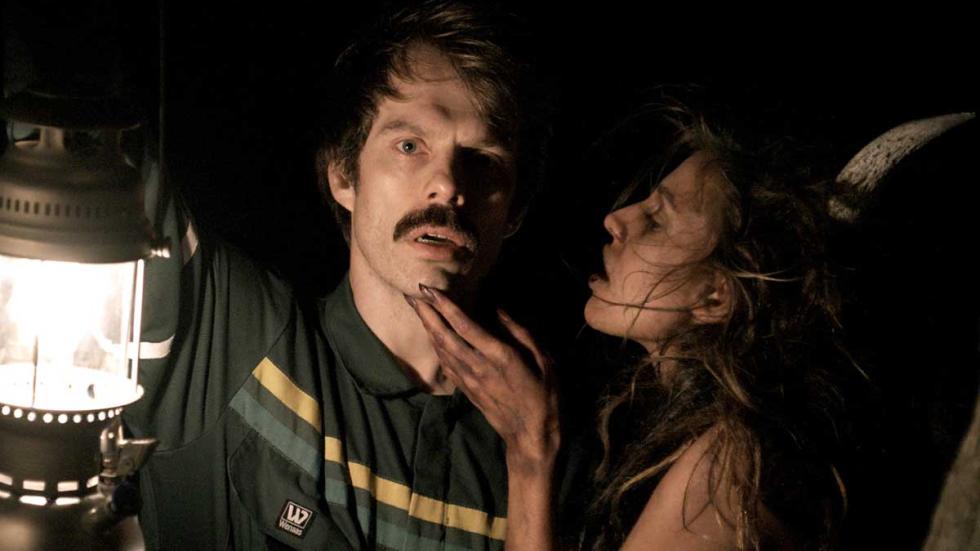 Vidar the Vampire film still Vidar holds lantern while being seduced by a woman