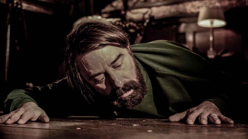 The Frozen Eye (L'Oeil Silencieux) film still man looks through hole in the floor