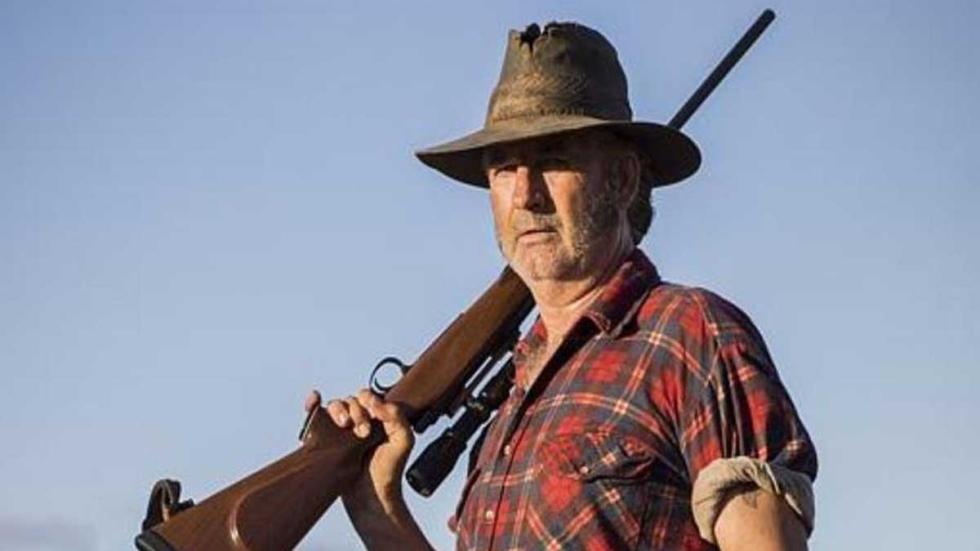Wolf Creek Mick Taylor holds a rifle