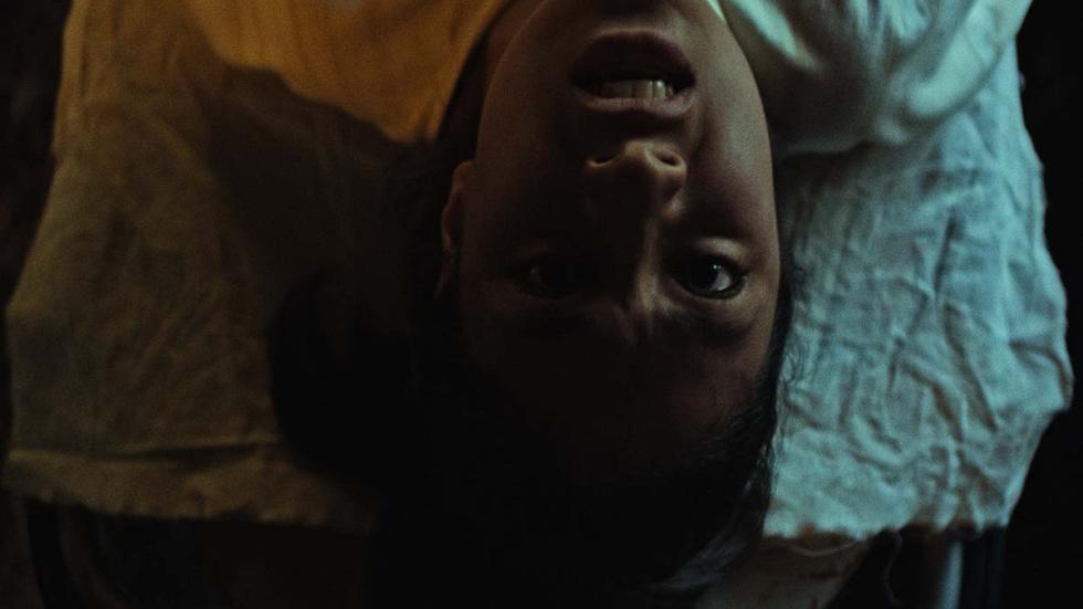 The Island of the Dolls film still scared man facing up