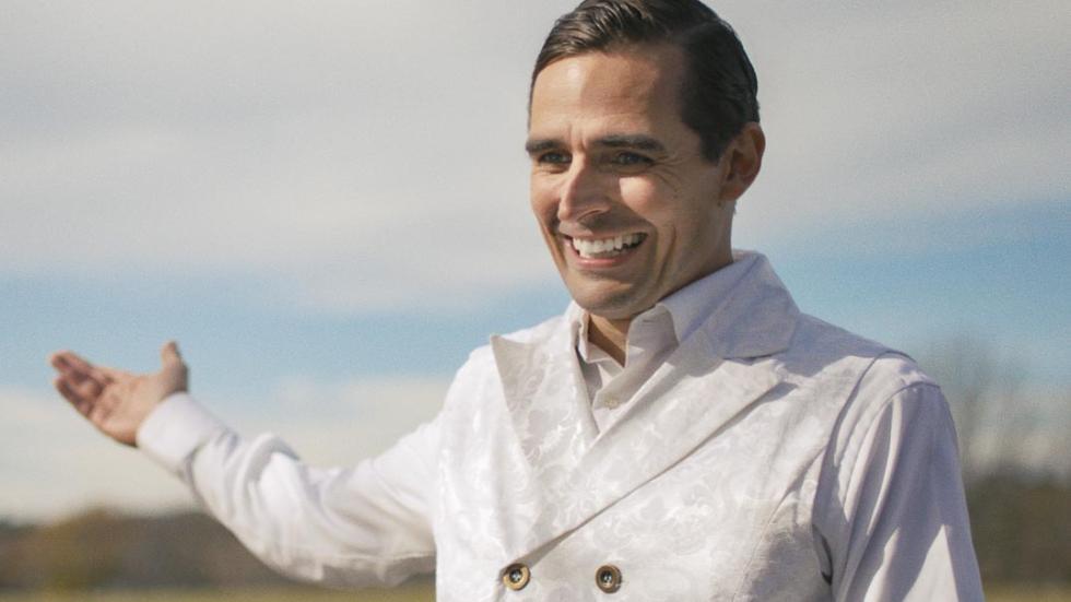 Film still man in white suit