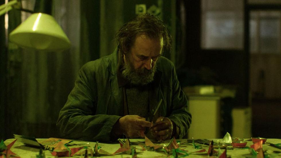 Z film still older man doing origami
