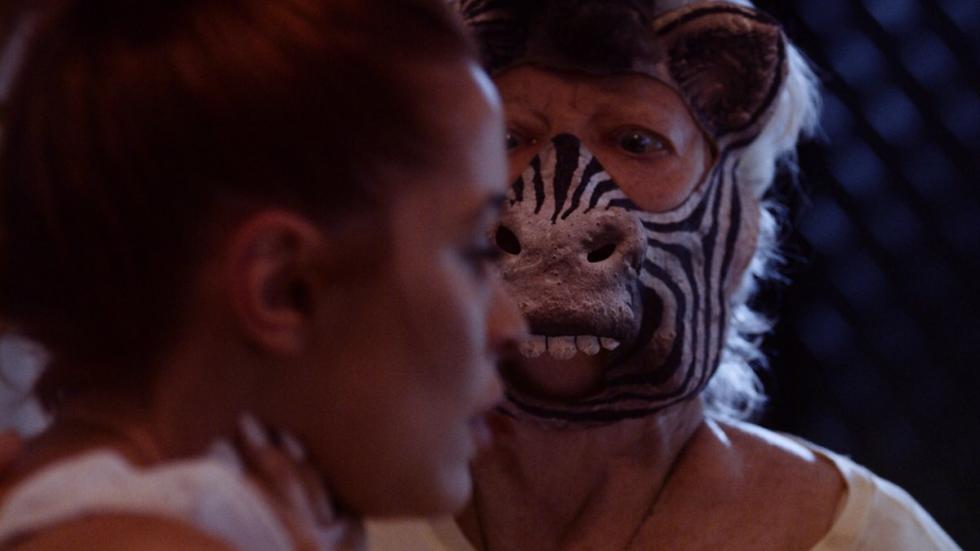Zebra film still of a zebra masked woman