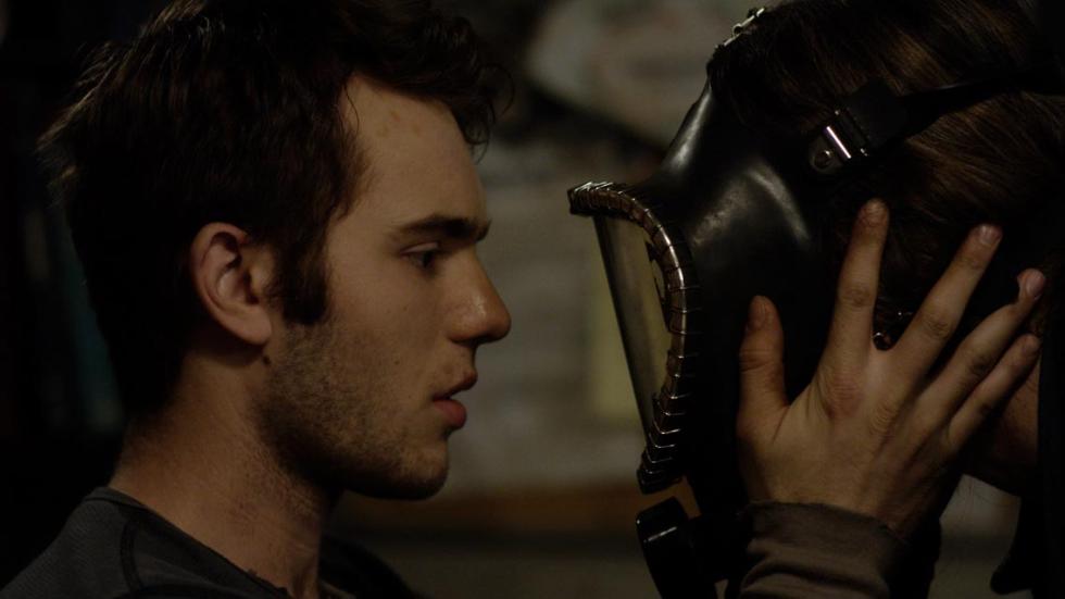 ZONE 2 young man looks at masked person