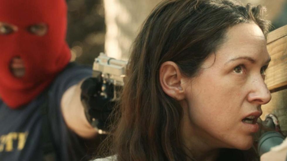 ZTV Sympathy for the Devil film still masked man pointing gun to woman's head.